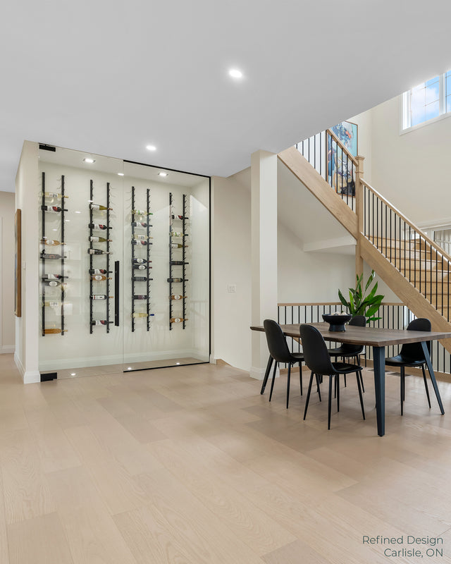 Classic wall mounted wine rack in home wine cellar and glass enclosed display, modern wine storage solution in bright dining room used by builders and interior designers