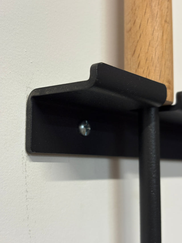 Wall-mounted fireplace tools with wooden handles close up on heavy duty metal bracket The Rack Co : Quebec Canada