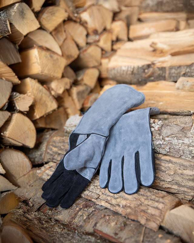 Heat-resistant leather fireplace gloves showing the soft interior lining and extended cuffs