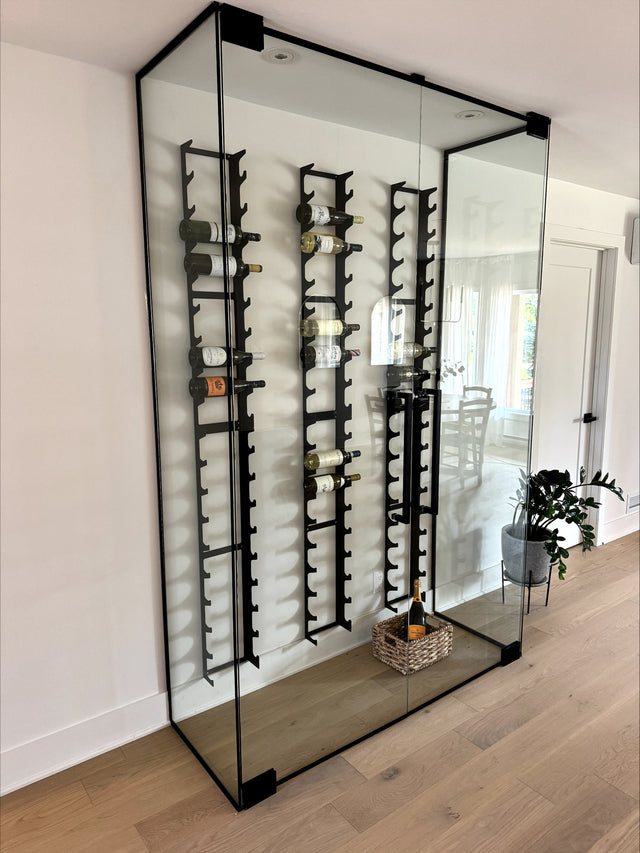 Modern home wine cellar featuring a custom wine wall with glass enclosure and Y Model wine racks stacked to hold 18 bottles; designed by Anne-Renée St-Cyr and made in Québec Canada.